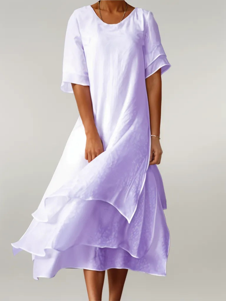 Vestido largo con falda en capas y mangas tres cuartos para un look sofisticado