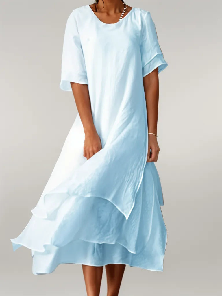 Vestido largo con falda en capas y mangas tres cuartos para un look sofisticado