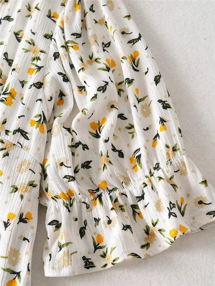 Vestido midi veraniego con escote en V y mangas abullonadas con delicado estampado floral