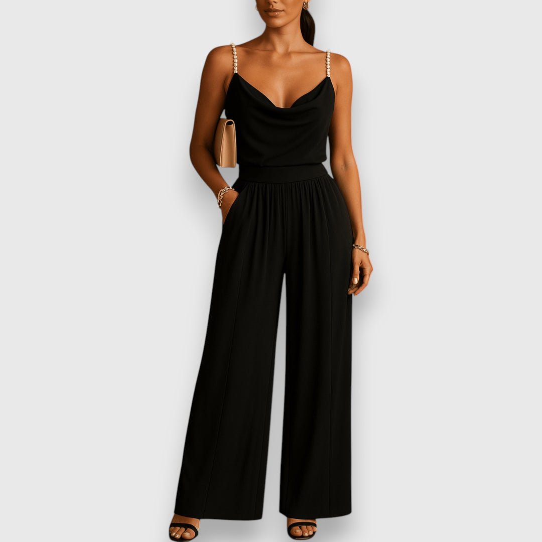 Mono elegante de tirantes finos con pantalones amplios plisados